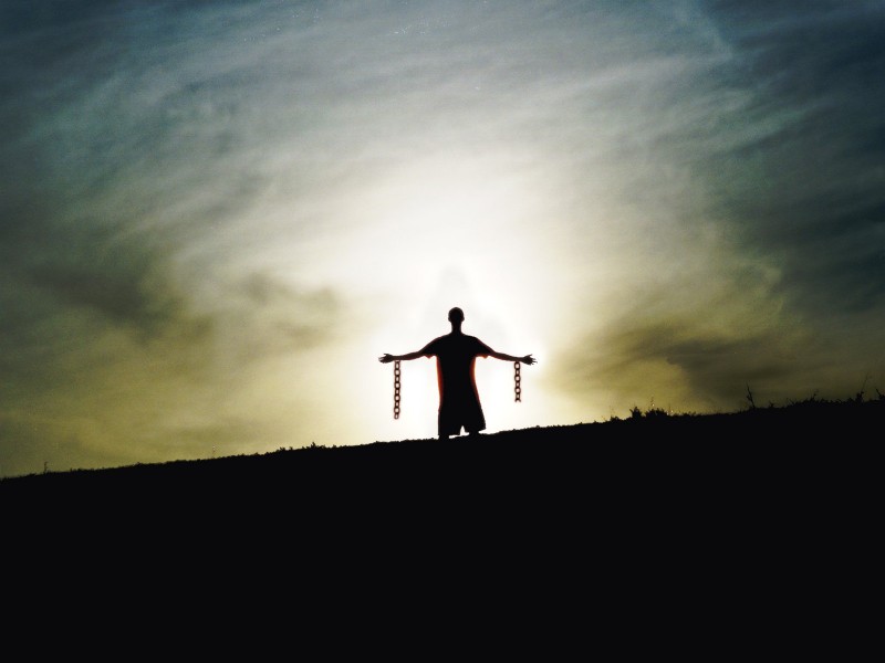 silhouette standing chains broken freedom from slavery.jpg